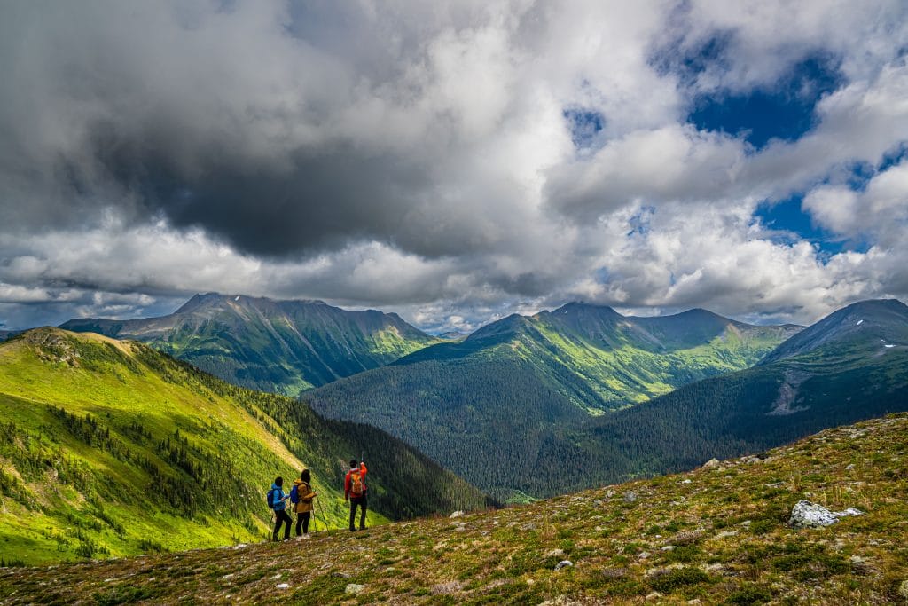 hikers walking alpine ridge in the Rocky Mountains British Columbia